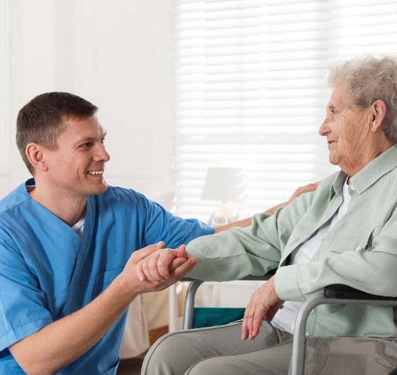 Professional holding patients hand smiling.