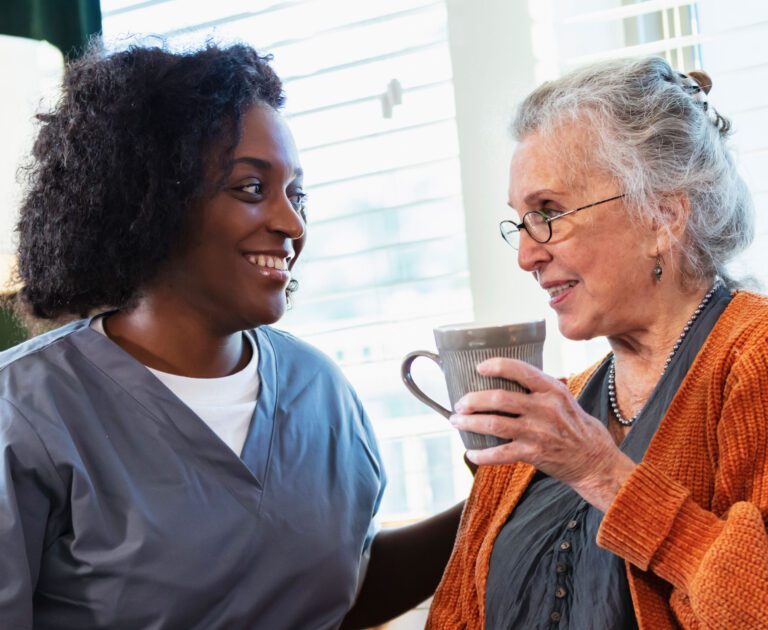 Woman PSW helping elderly woman